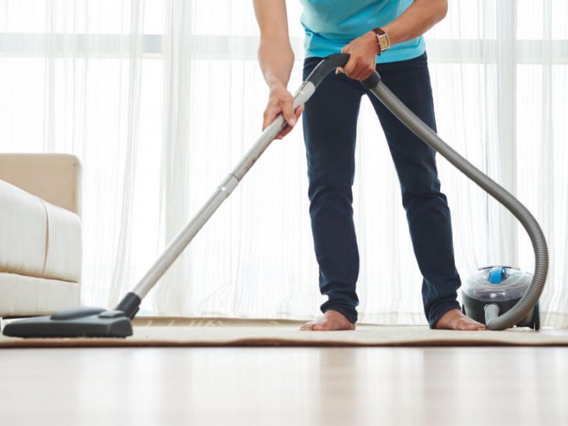 lower-body-shot-unrecognizable-man-vacuuming-carpet-home (1)